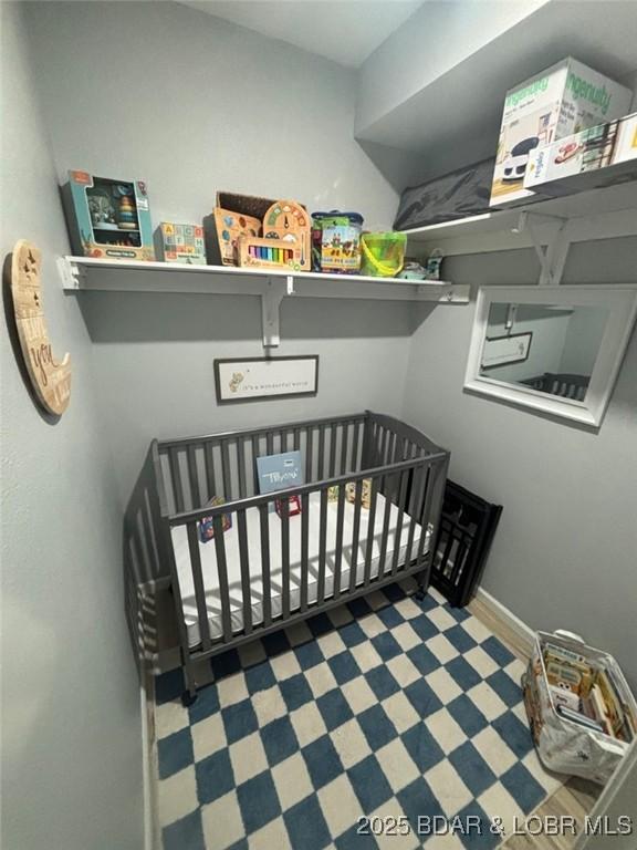 1481 Ledges Dr Unit 1019, Osage Beach, MO 65065 - bedroom with a nursery area, baseboards, and tile patterned floors