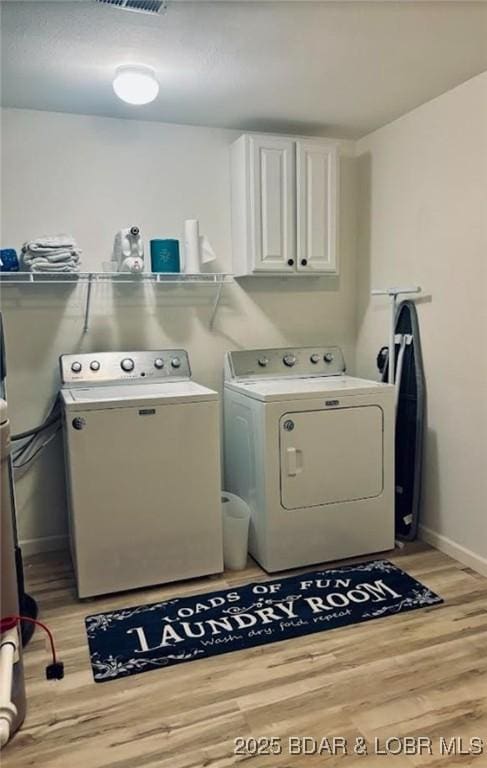1481 Ledges Dr Unit 1019, Osage Beach, MO 65065 - laundry room featuring washer and dryer, cabinet space, light wood-type flooring, and baseboards
