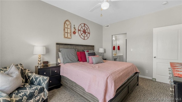 carpeted bedroom featuring baseboards, ensuite bathroom, and a ceiling fan