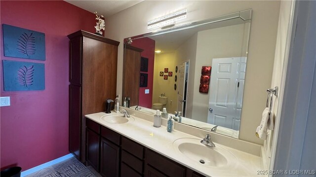18130 Millstone Cove Rd Unit 447, Gravois Mills, MO 65037 - bathroom with toilet, double vanity, baseboards, and tile patterned floors