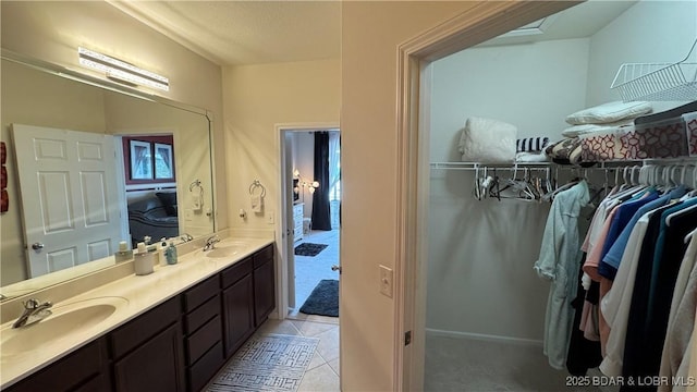 18130 Millstone Cove Rd Unit 447, Gravois Mills, MO 65037 - ensuite bathroom featuring double vanity, tile patterned floors, and a walk in closet