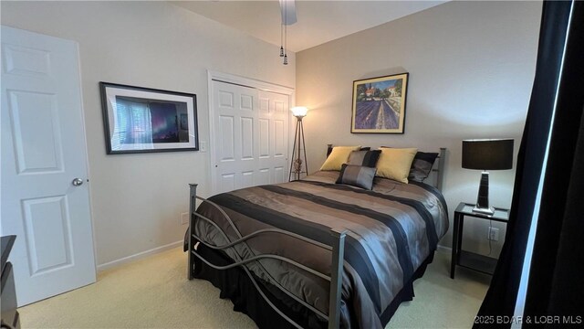 18130 Millstone Cove Rd Unit 447, Gravois Mills, MO 65037 - bedroom with light colored carpet, baseboards, a closet, and ceiling fan