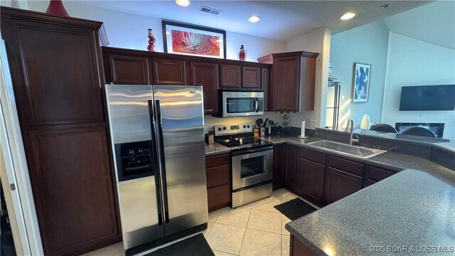 18130 Millstone Cove Rd Unit 447, Gravois Mills, MO 65037 - kitchen with stainless steel appliances, a sink, dark countertops, recessed lighting, and light tile patterned flooring