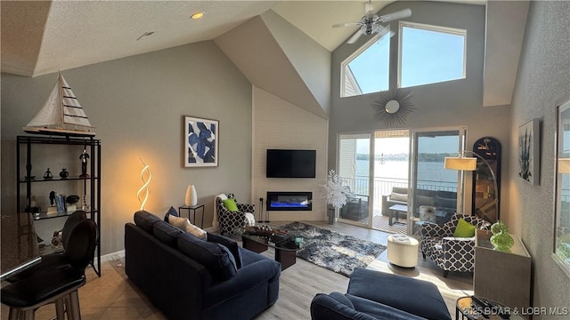 18130 Millstone Cove Rd Unit 447, Gravois Mills, MO 65037 - living room featuring a ceiling fan, a large fireplace, and high vaulted ceiling