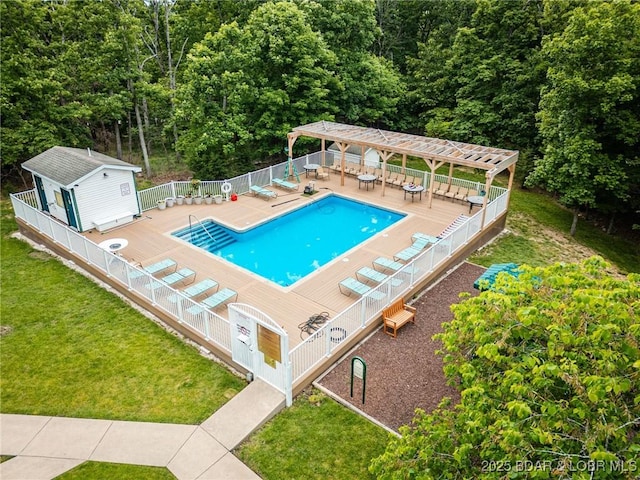 community pool featuring a pergola, a deck, an outdoor structure, and a forest view