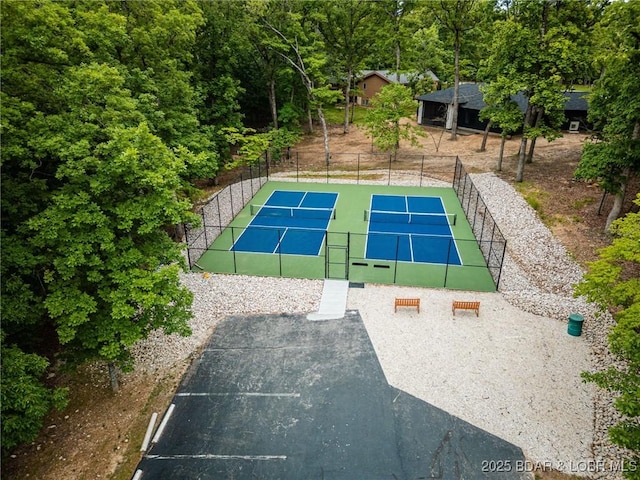 view of tennis court featuring fence