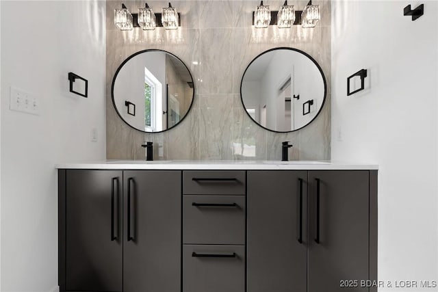 bathroom featuring backsplash, double vanity, and a chandelier