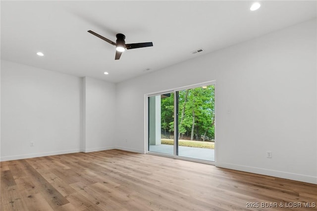 empty room featuring a ceiling fan, wood finished floors, recessed lighting, and baseboards