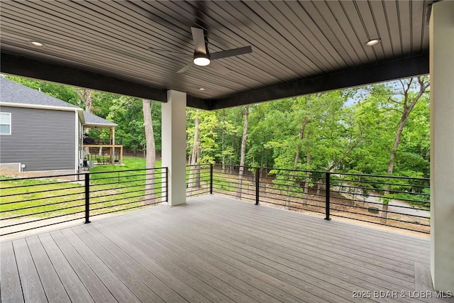 wooden deck featuring ceiling fan