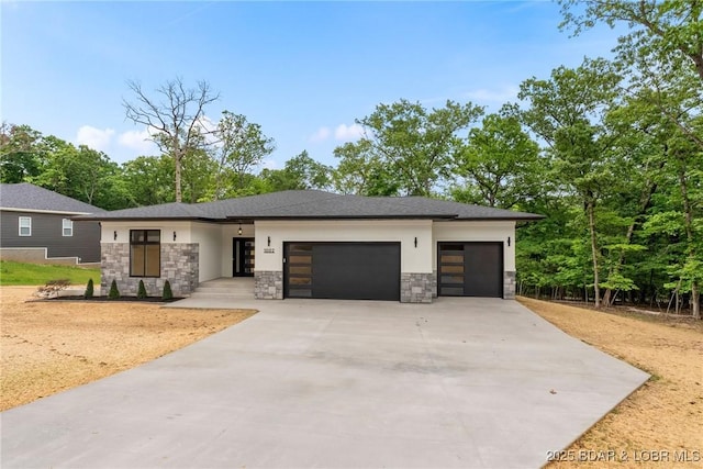 prairie-style house featuring stone siding, an attached garage, concrete driveway, and stucco siding