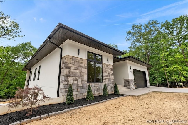 view of home's exterior with stone siding, stucco siding, concrete driveway, and a garage