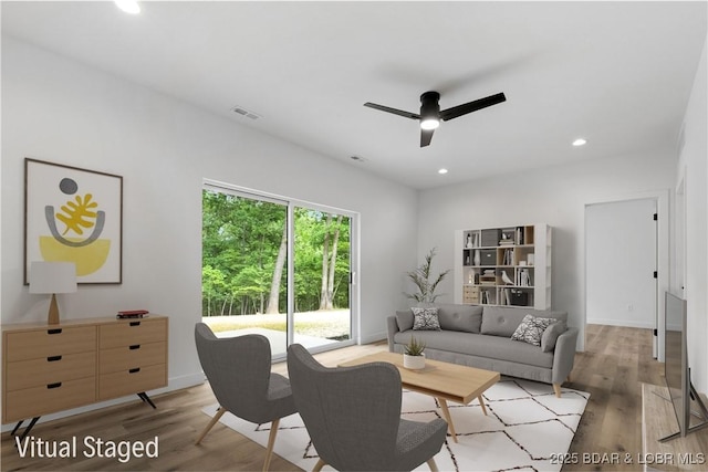 living area with a ceiling fan, light wood-style flooring, recessed lighting, and baseboards