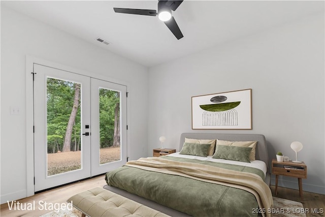 bedroom featuring french doors, access to exterior, wood finished floors, and baseboards