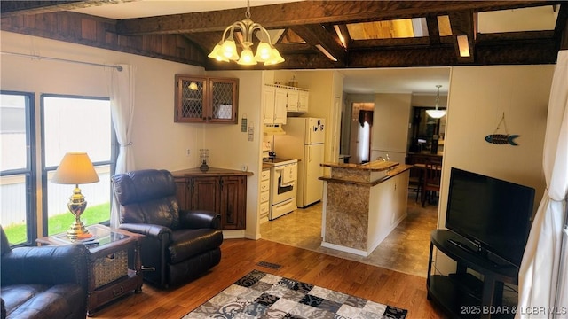 living room featuring wood finished floors and a chandelier