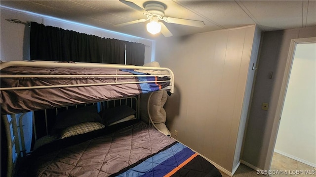 bedroom with a ceiling fan and baseboards