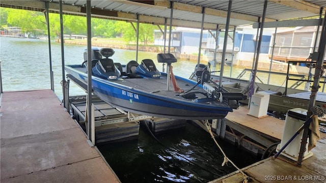 dock area with boat lift and a water view