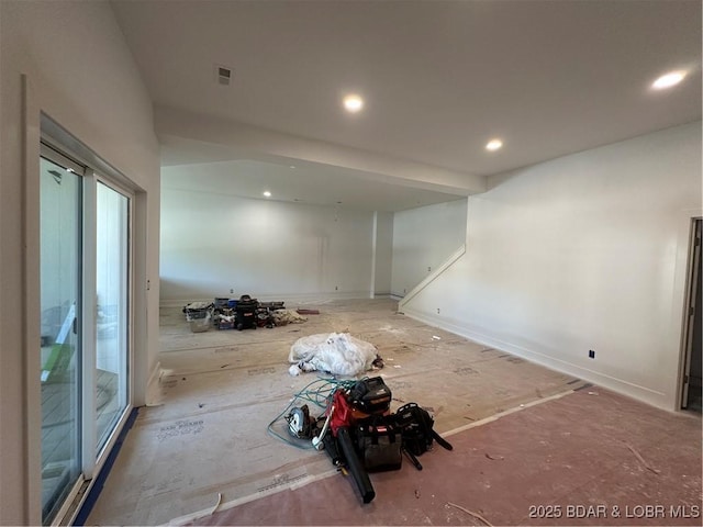 unfurnished living room with recessed lighting