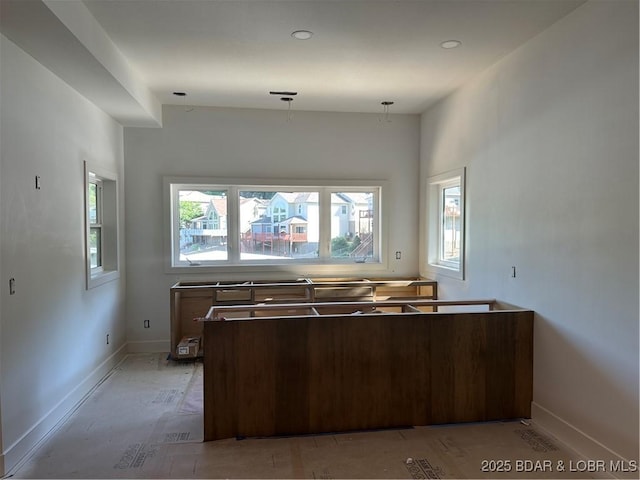 kitchen with baseboards and hanging light fixtures