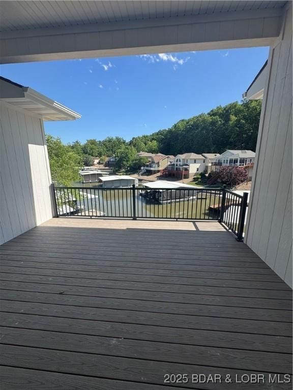deck featuring view of wooded area