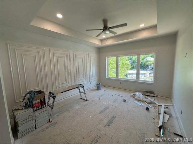 unfurnished bedroom featuring a raised ceiling, baseboards, and recessed lighting
