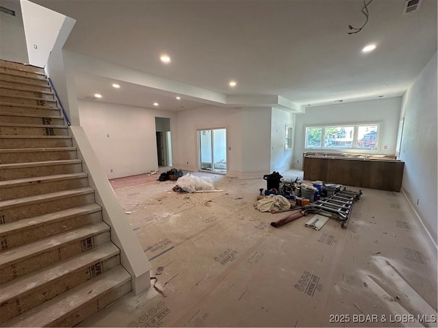 living room with stairway and recessed lighting