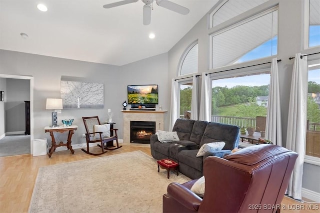 5183 Vicus Castri, Osage Beach, MO 65065 - living area featuring a fireplace, a ceiling fan, light wood-style flooring, high vaulted ceiling, and baseboards