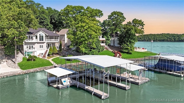 5482 Stoneledge Cir, Osage Beach, MO 65065 - dock with boat lift, stairway, a water view, and a lawn