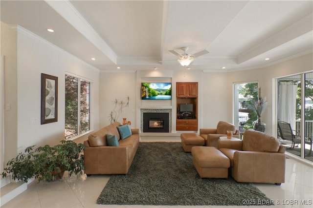 5482 Stoneledge Cir, Osage Beach, MO 65065 - living room with ornamental molding, a glass covered fireplace, light tile patterned flooring, a ceiling fan, and recessed lighting