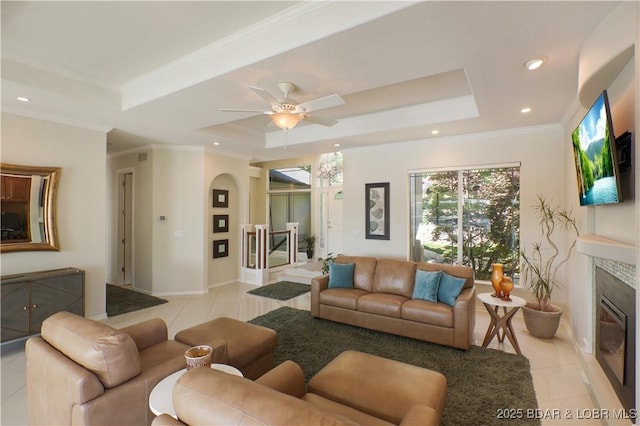 5482 Stoneledge Cir, Osage Beach, MO 65065 - living area with a tray ceiling, light tile patterned floors, a premium fireplace, ceiling fan, and baseboards