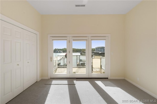 5482 Stoneledge Cir, Osage Beach, MO 65065 - unfurnished bedroom featuring carpet flooring, access to exterior, baseboards, a closet, and french doors