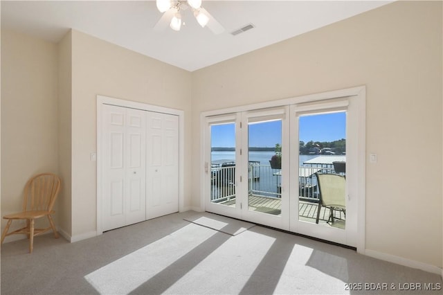 5482 Stoneledge Cir, Osage Beach, MO 65065 - unfurnished bedroom featuring access to outside, carpet floors, a closet, a ceiling fan, and a water view