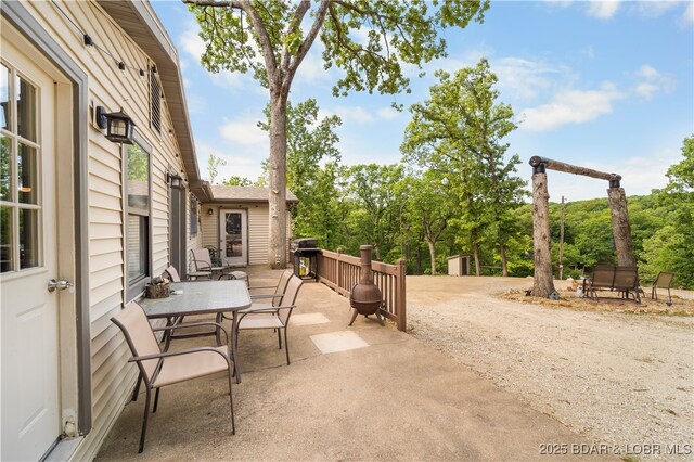 66 Old Shawnee Bend Rd, Sunrise Beach, MO 65079 - view of patio / terrace featuring outdoor dining area, grilling area, and a storage shed