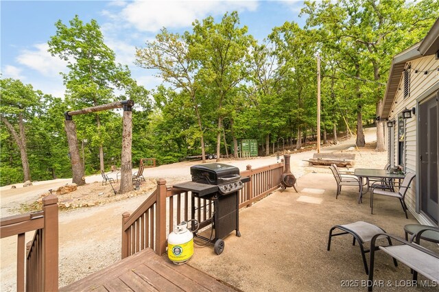 66 Old Shawnee Bend Rd, Sunrise Beach, MO 65079 - wooden deck featuring area for grilling and view of wooded area
