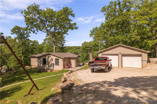 66 Old Shawnee Bend Rd, Sunrise Beach, MO 65079 - view of front of property featuring a detached garage, an outbuilding, and a front yard
