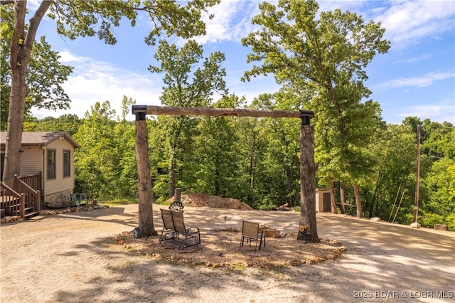 66 Old Shawnee Bend Rd, Sunrise Beach, MO 65079 - view of patio / terrace featuring a storage unit, an outbuilding, and driveway