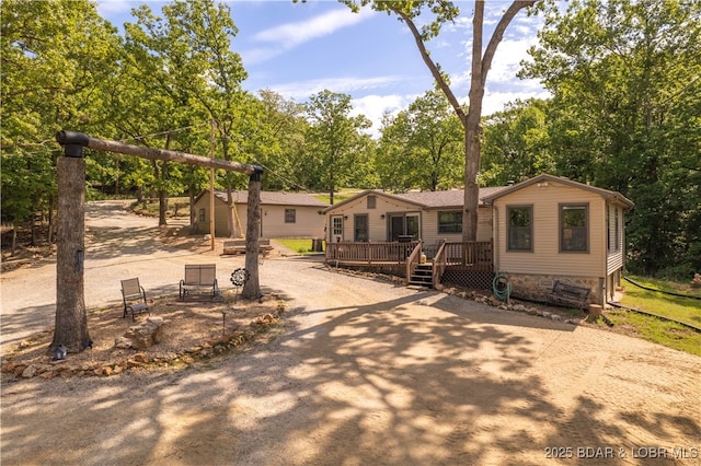 66 Old Shawnee Bend Rd, Sunrise Beach, MO 65079 - view of front facade featuring a wooden deck and view of wooded area