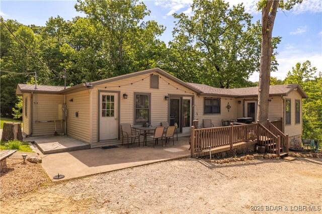 66 Old Shawnee Bend Rd, Sunrise Beach, MO 65079 - rear view of property with a patio area and a wooden deck