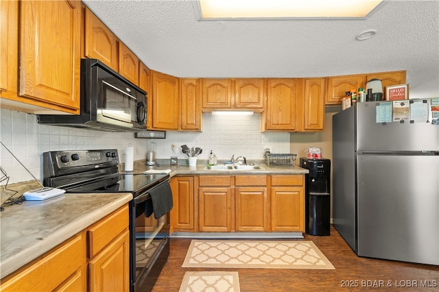 66 Old Shawnee Bend Rd, Sunrise Beach, MO 65079 - kitchen with black appliances, a sink, dark wood-style flooring, light countertops, and tasteful backsplash