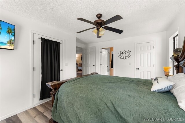 66 Old Shawnee Bend Rd, Sunrise Beach, MO 65079 - bedroom featuring wood finished floors, baseboards, ceiling fan, and a textured ceiling