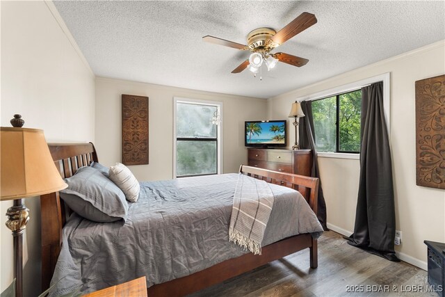 66 Old Shawnee Bend Rd, Sunrise Beach, MO 65079 - bedroom with wood finished floors, a textured ceiling, crown molding, ceiling fan, and baseboards