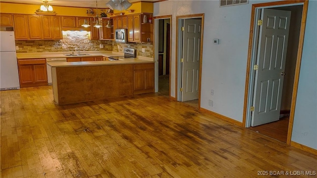 26587 Lake Front Ln, Rocky Mount, MO 65072 - kitchen featuring appliances with stainless steel finishes, light countertops, and light wood-type flooring