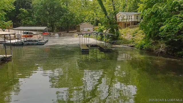 26587 Lake Front Ln, Rocky Mount, MO 65072 - water view featuring a boat dock and a heavily wooded area
