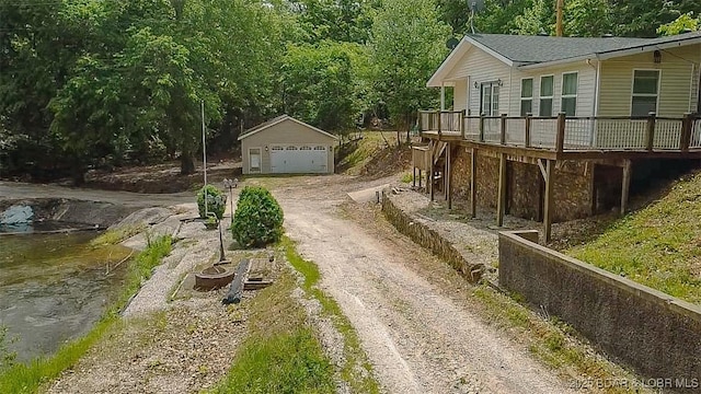 26587 Lake Front Ln, Rocky Mount, MO 65072 - view of property exterior featuring a wooden deck, an outbuilding, and a garage
