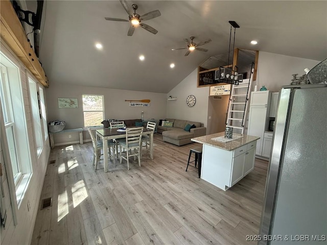 23848 Bill Bryant Dr, Warsaw, MO 65355 - kitchen with freestanding refrigerator, ceiling fan, lofted ceiling, white cabinets, and light wood-style flooring