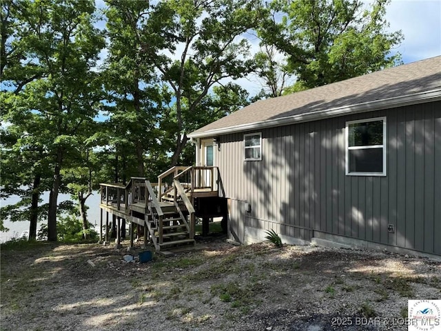 23848 Bill Bryant Dr, Warsaw, MO 65355 - view of side of home featuring stairway, a shingled roof, and a deck