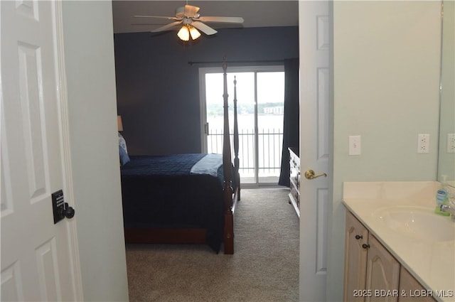 bedroom featuring carpet flooring, a sink, access to outside, and a ceiling fan