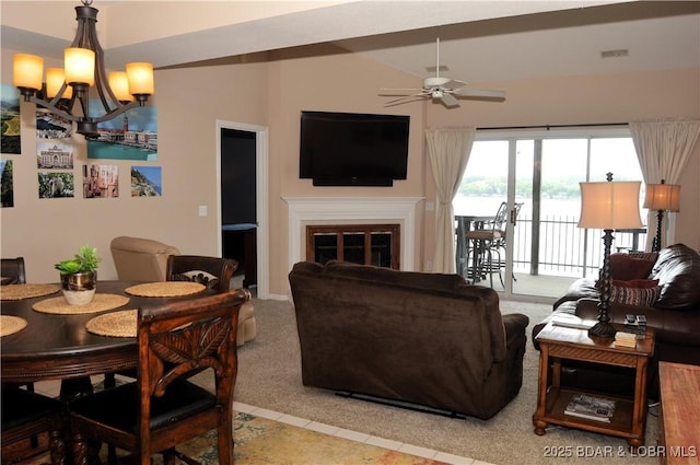 carpeted living room with ceiling fan, a chandelier, a glass covered fireplace, and tile patterned flooring