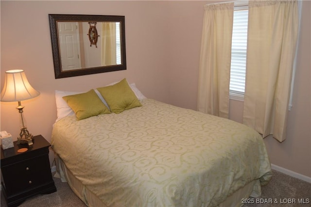 bedroom featuring carpet floors and baseboards