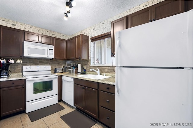 kitchen featuring white appliances, a sink, tasteful backsplash, dark brown cabinets, and a textured ceiling