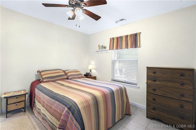 bedroom featuring light tile patterned flooring, baseboards, and a ceiling fan